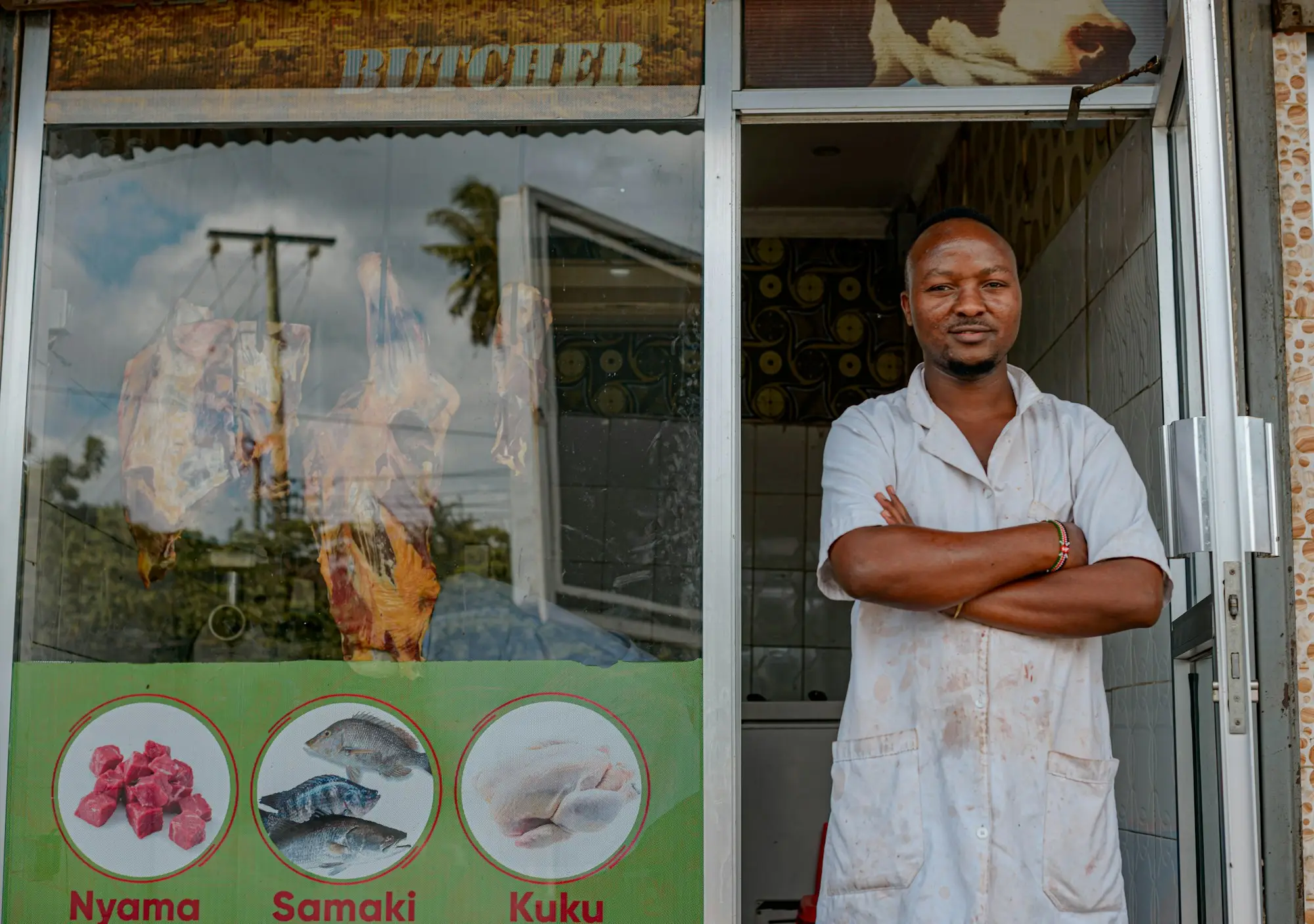 Shop owner standing outside his store